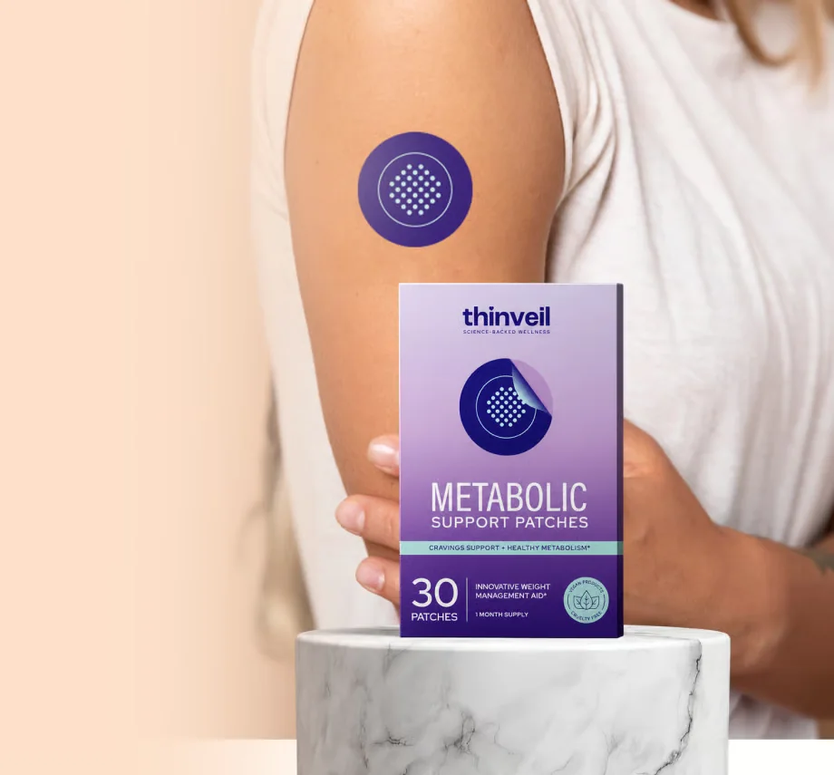 Woman wearing a Thinveil wellness patch on her upper arm, holding a box of Thinveil Metabolic Support Patches